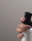 Gif showing a hand pressing on the nozzle of the Multitasking Mist