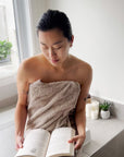 A picture of a person sitting on the side of a bath tube