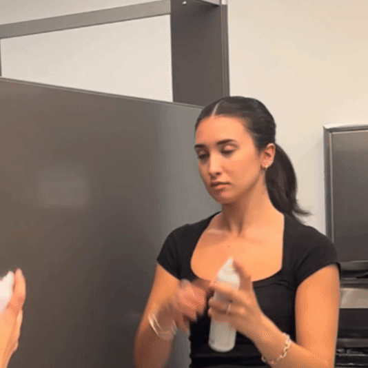 Gif showing someone in a bathroom using the Alcove Hair Strong Hold Hairspray