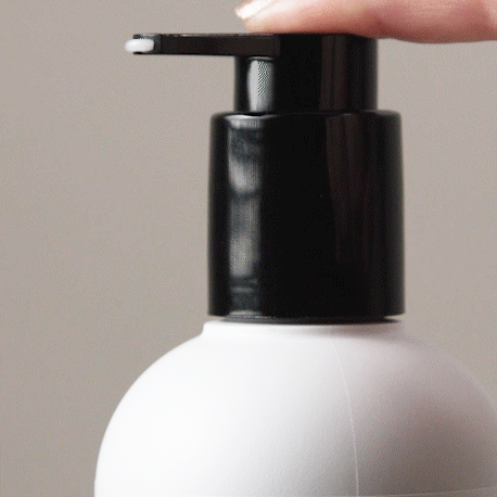 Gif showing someone press on the Mini Styling Cream - Alcôve Hair pump with liquid coming out