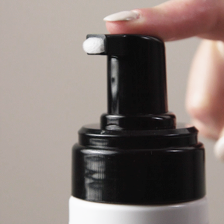 Gif showing a finger pressing on the nozzle of the Volumizing Mousse showing the texture of the product.