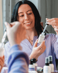 Picture showing a girl demonstrating the Bottle of Alcove Hair Pre-Wash Scalp Oil