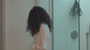 Video showing a model using the Alcôve Hair Curl Shampoo and Curl Conditioner in a shower